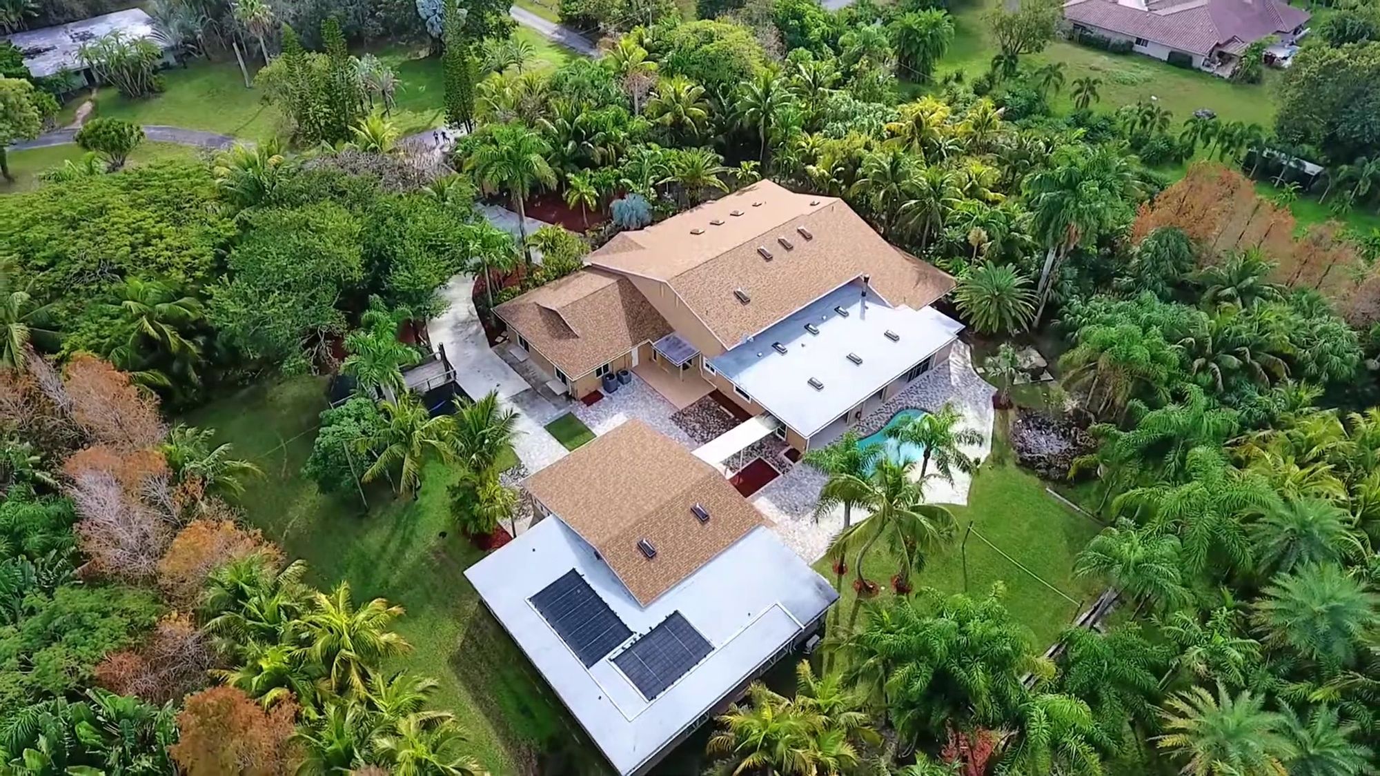 Directly overhead aerial photograph of a property showing roof condition, mechanical equipment and grounds